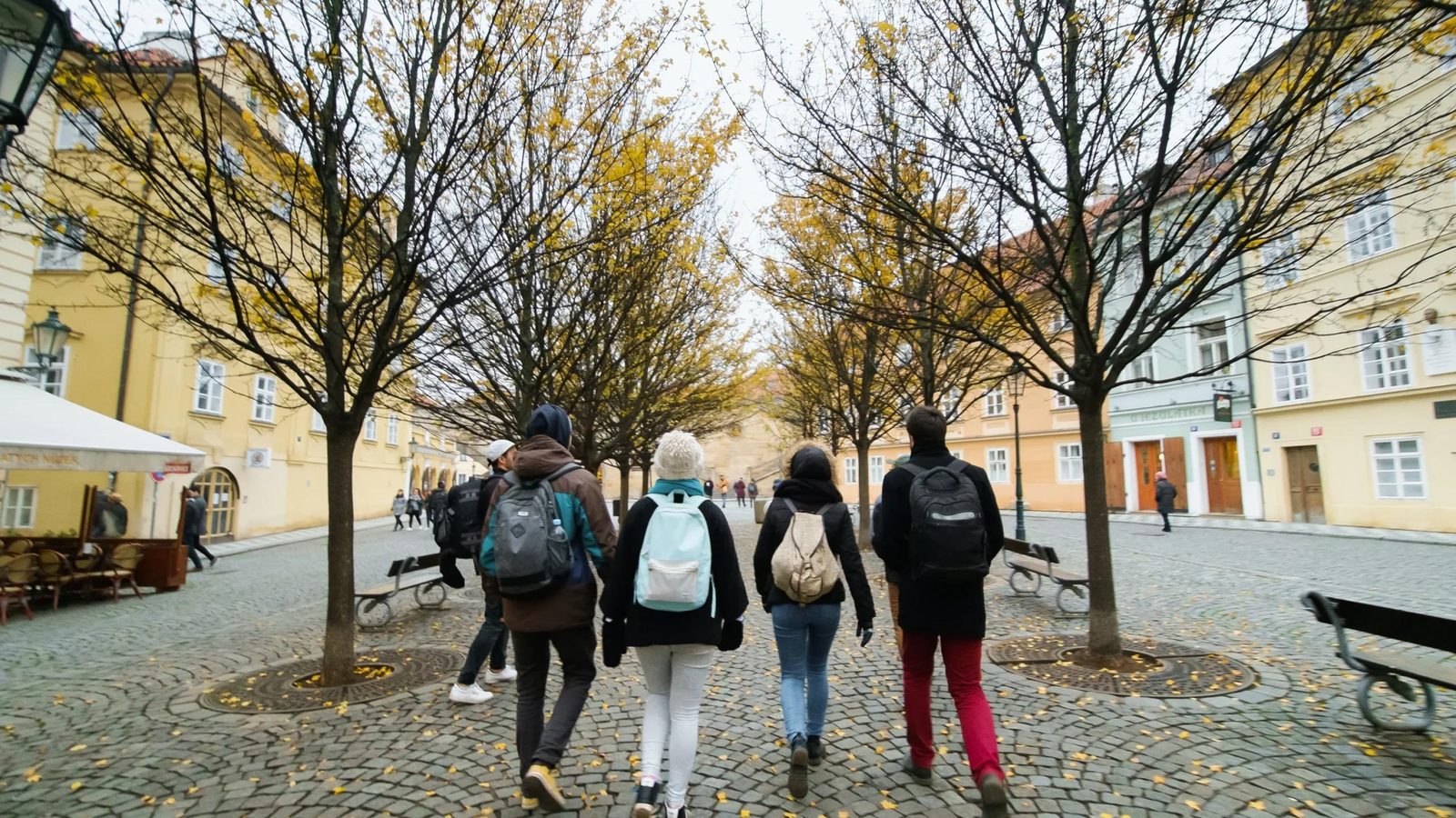Group of international students walking through a Prague square
